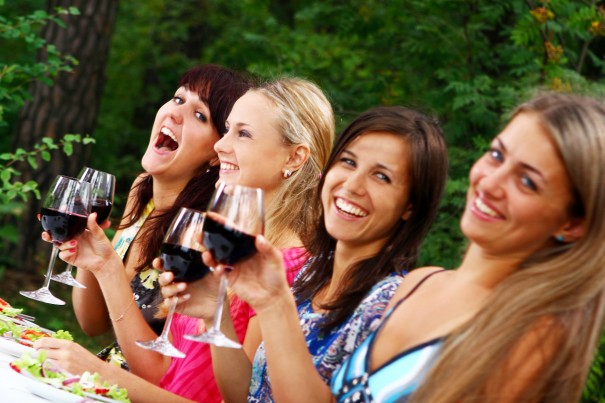 group of beautiful girls drinking wine