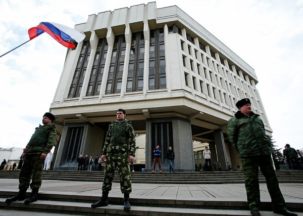 Members of Crimean self-defence units guard the Crimean parliament building in Simferopol