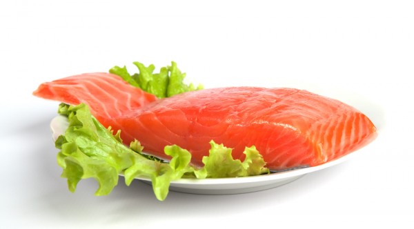 Salmon steak on leaves of salad