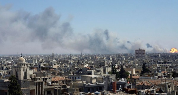 Flame and smoke rise from the district of southeastern Wadi al-Dhahab in Homs